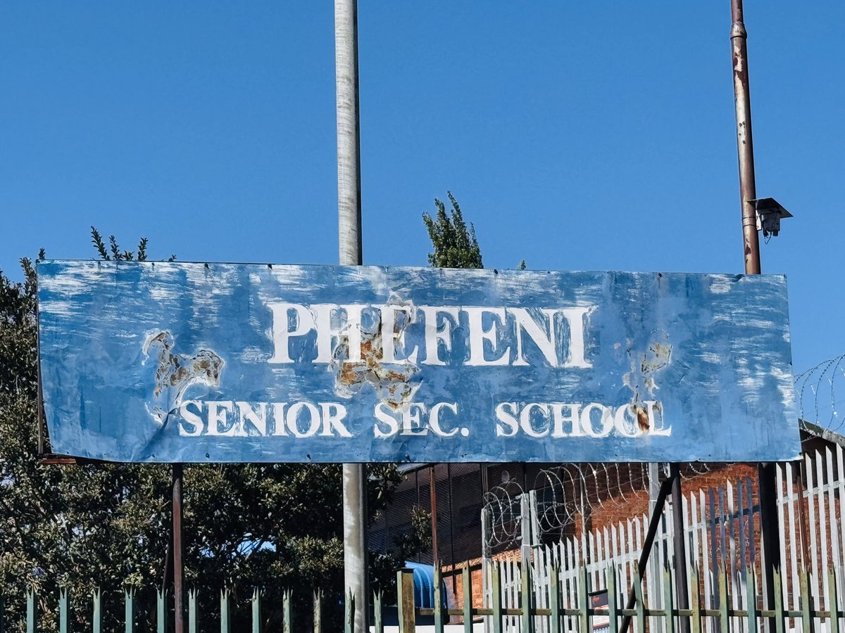 The weathered Phefeni Senior Secondary School entrance sign before the intervention.